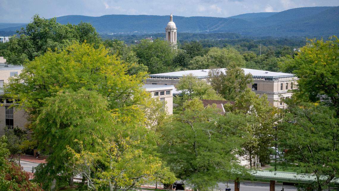 The bell tower of Old Main sticks out above the trees on the Penn State campus on Monday, Sept. 12, 2022.