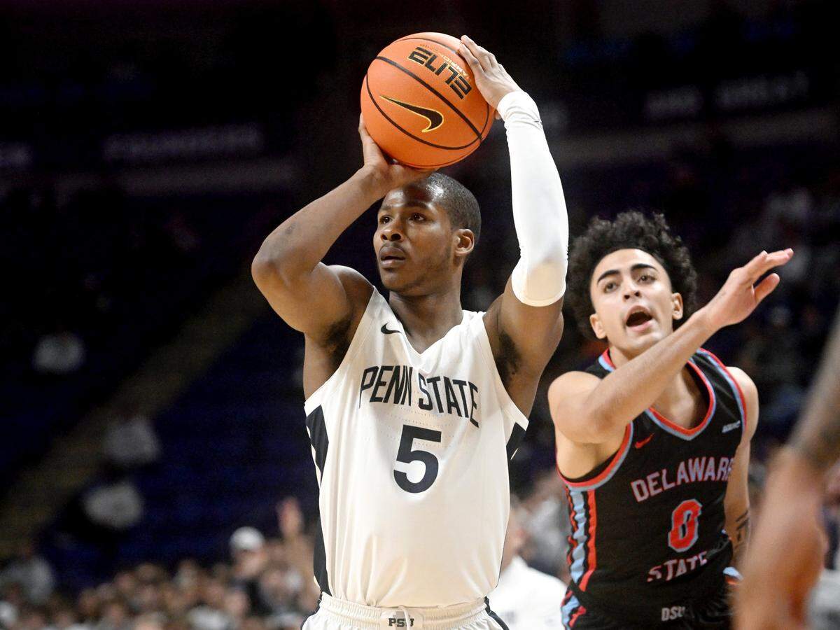 Delaware State’s Deywilk Tavarez can’t stop Penn State’s Jameel Brown as he shoots a three pointer during the game on Monday, Nov. 6, 2023.