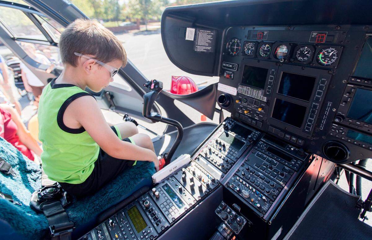 Hudson Manning checks out all the buttons in the cockpit of the Geisinger Life Flight helicopter during the Patton Township Children’s Fair on Sept. 23, 2017.
