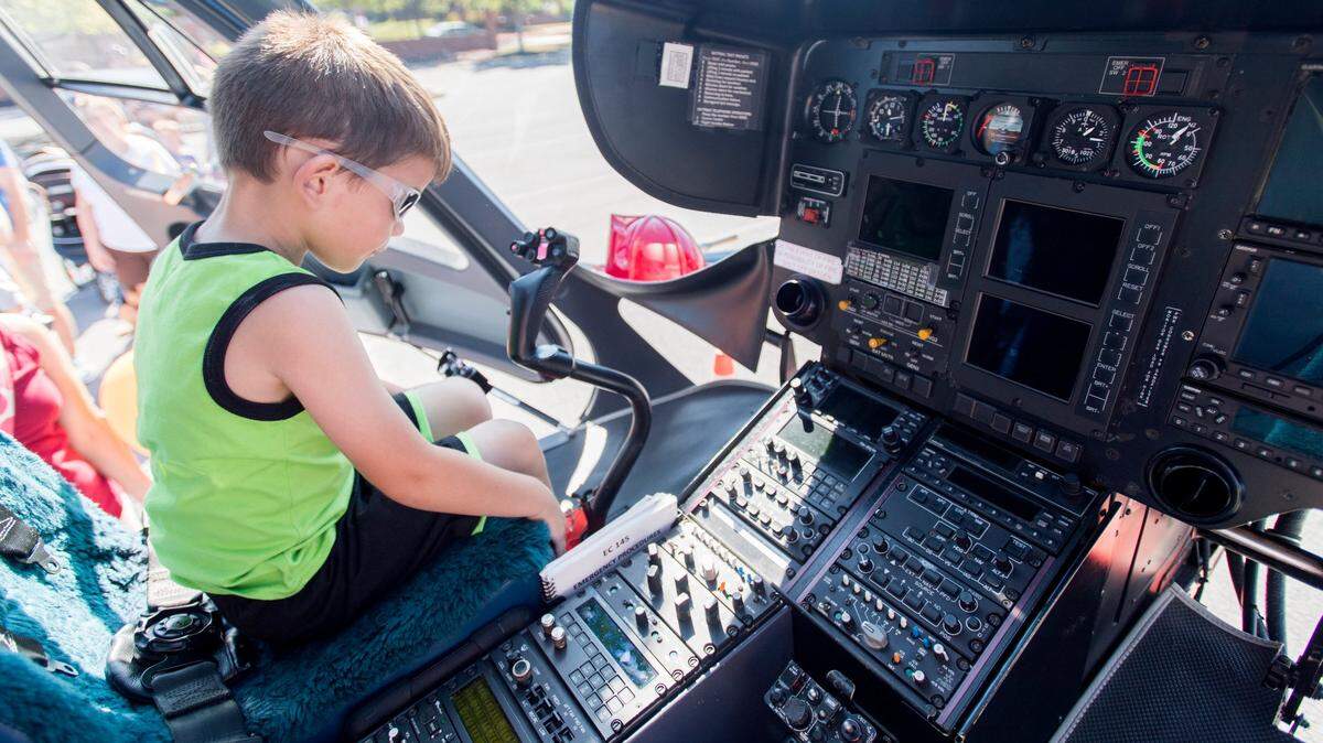 Hudson Manning checks out the buttons in the cockpit of the Geisinger Life Flight helicopter during the 2017 Patton Township Children’s Fair.