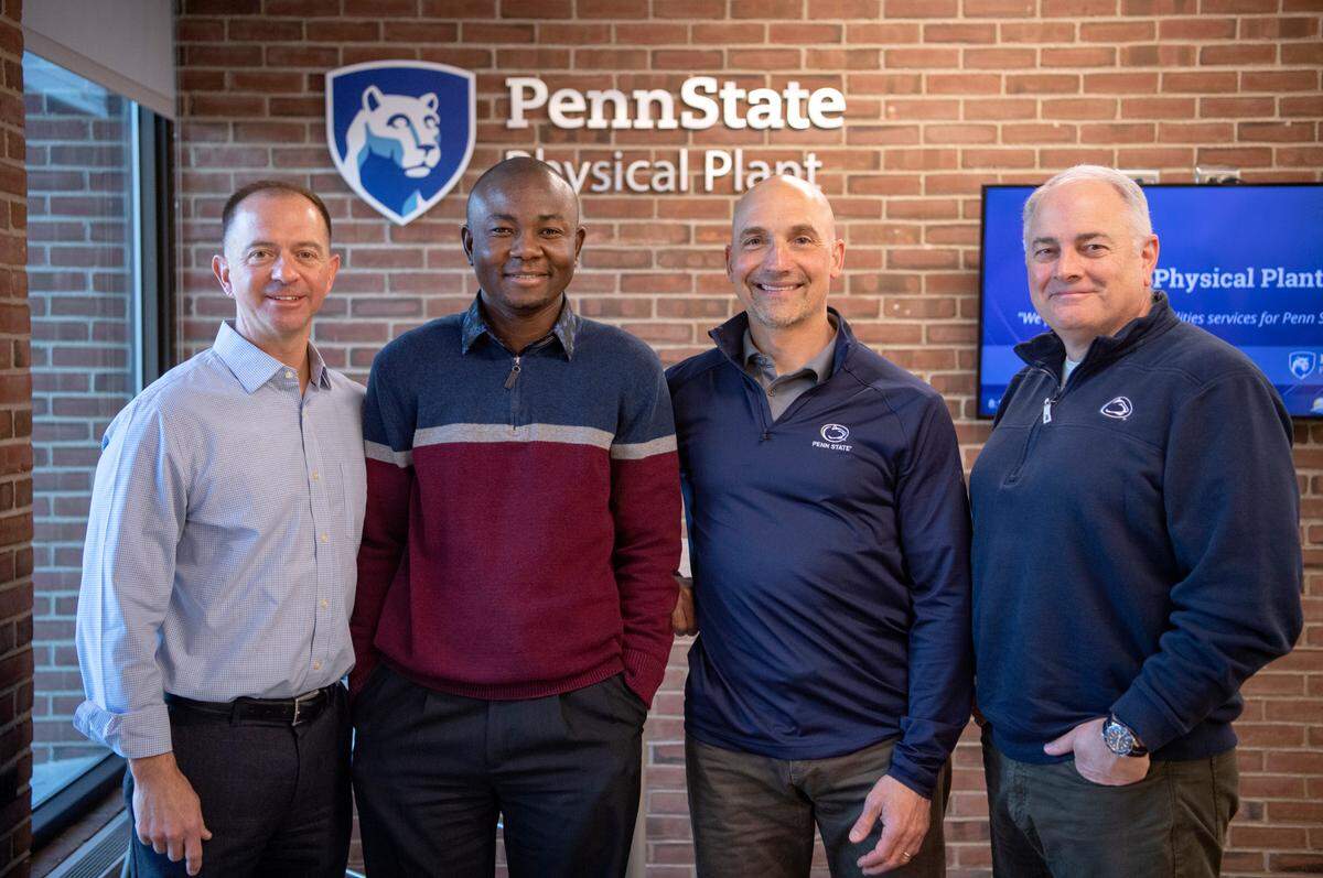 Penn State OPP’s Vice President and Chief Facilities Officer Bill Sitzabee, recycling program manager Ayodeji Oluwalana, assistant Vice President of operations Russ Rang and assistance Vice President for physical plant Mark Miller in the lobby of the Physical Plant building on April 8.