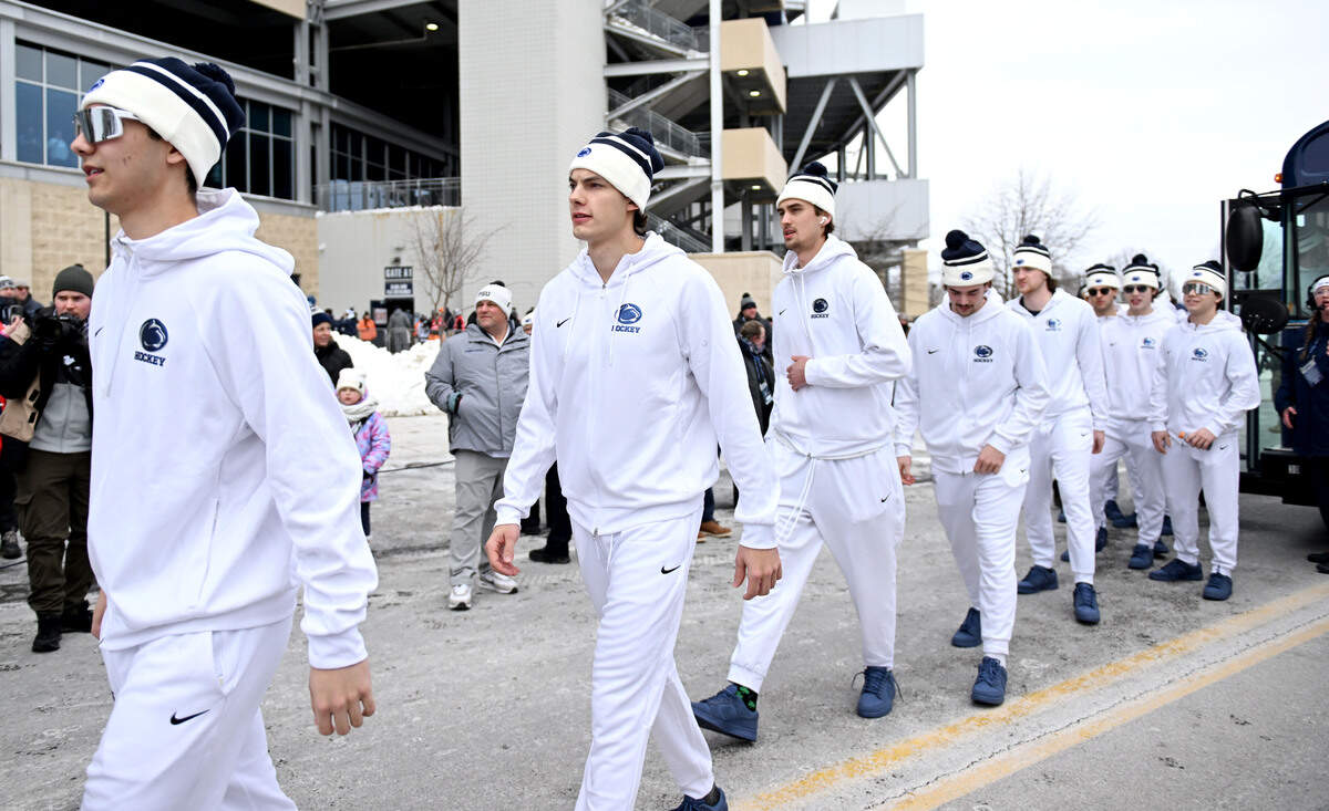 The Penn State men’s hockey team wears all white as they walk past fans to Beaver Stadium for the game against Michigan State on Saturday, Jan. 31, 2026.