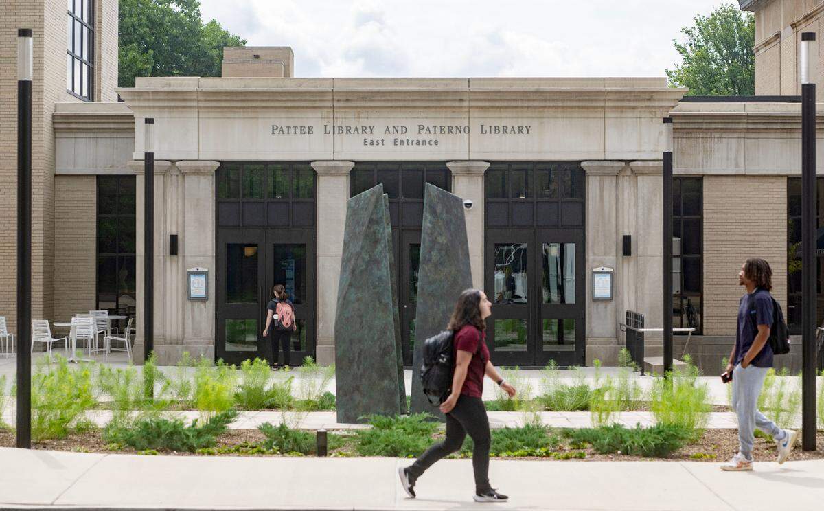 Students walk on the Penn State campus by the Pattee Paterno Library on Thursday, July 18, 2024.
