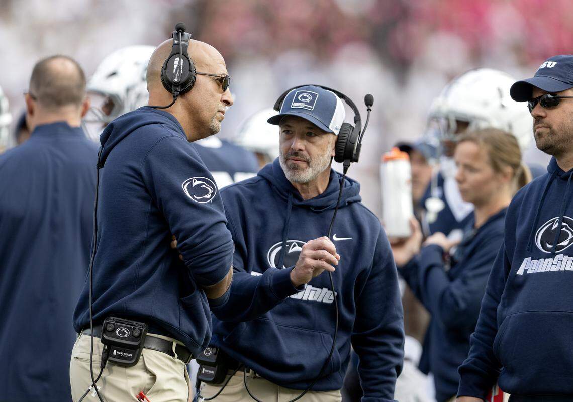 Penn State football coach James Franklin and special teams coordinator Justin Lustig talk during a timeout of the game against Northwestern on Saturday, Oct. 11, 2025.  