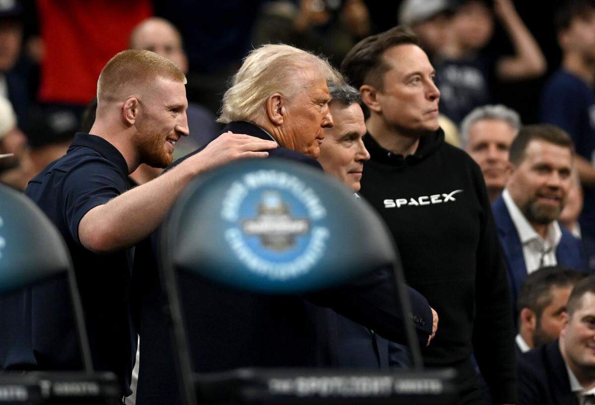 President Donald Trump poses for a photo with Bo Nickal, Dave McCormick and Elon Must at the 2025 NCAA Wrestling Championships at the Wells Fargo Center in Philadelphia on Saturday March 22, 2025.