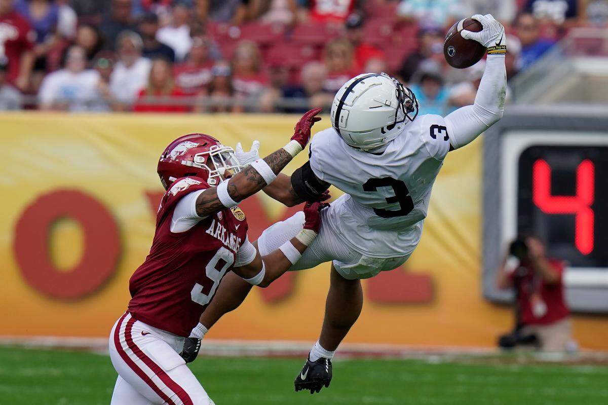 Penn State wide receiver Parker Washington (3) makes a one-handed catch in front of Arkansas defensive back Greg Brooks Jr. during the first half of the Outback Bowl NCAA college football game Saturday, Jan. 1, 2022, in Tampa, Fla.
