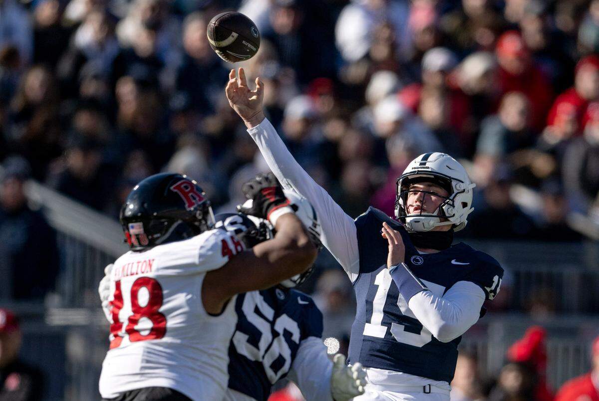 Penn State quarterback Drew Allar makes a pass over Rutgers defenders during the game on Saturday, Nov. 18, 2023.