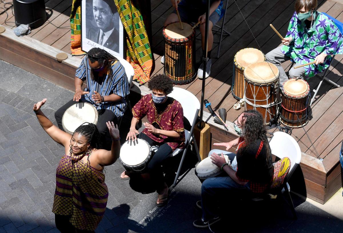 Joy Roberston dances as members of Roots of Life play during the inaugural Juneteenth celebration hosted by the State College NAACP at MLK Plaza in State College on Friday, June 19, 2020.