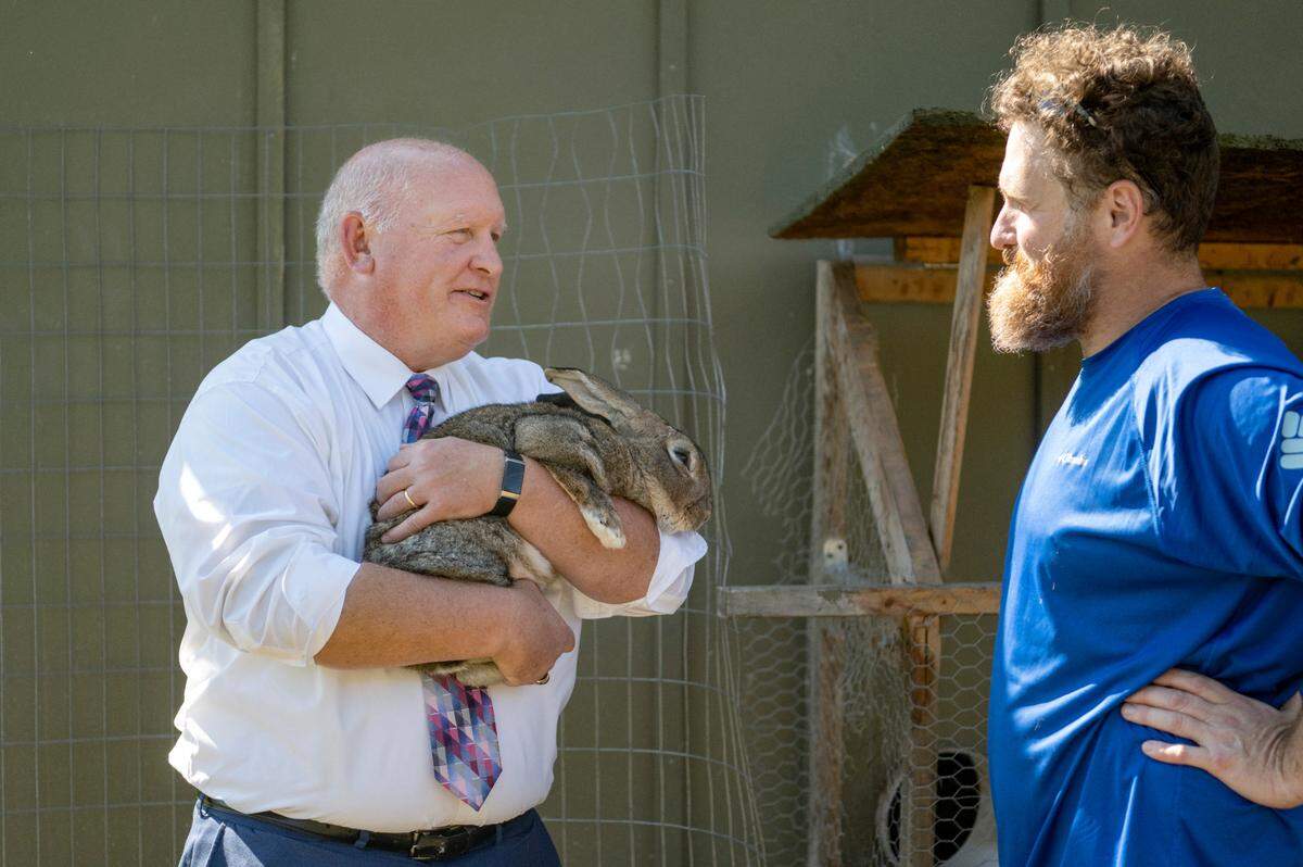 Congressman Glenn Thompson holds Flanders, a Flemish Giant rabbit, at Resilency Farm as he talks with owner Matt Bacon on Thursday, Oct. 6, 2022.