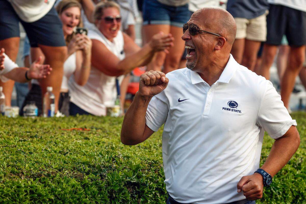 Penn State head coach James Franklin celebrates with fans after their victory over Auburn on Saturday at Jordan-Hare Stadium.
