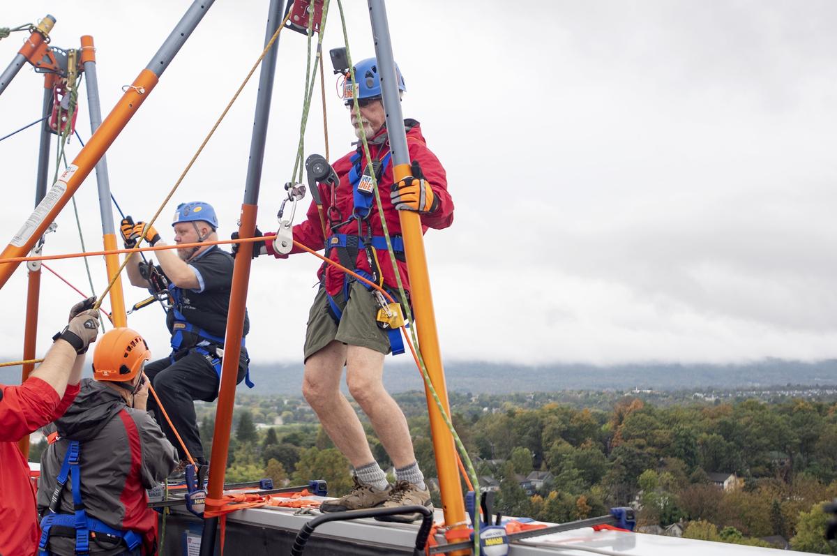 Bellefonte Mayor Tom Wilson gets ready to rappel from the roof of the Fraser Centre on Thursday as part of the State College Over the Edge event to raise money for FaithCentre and Interfaith Human Services.
