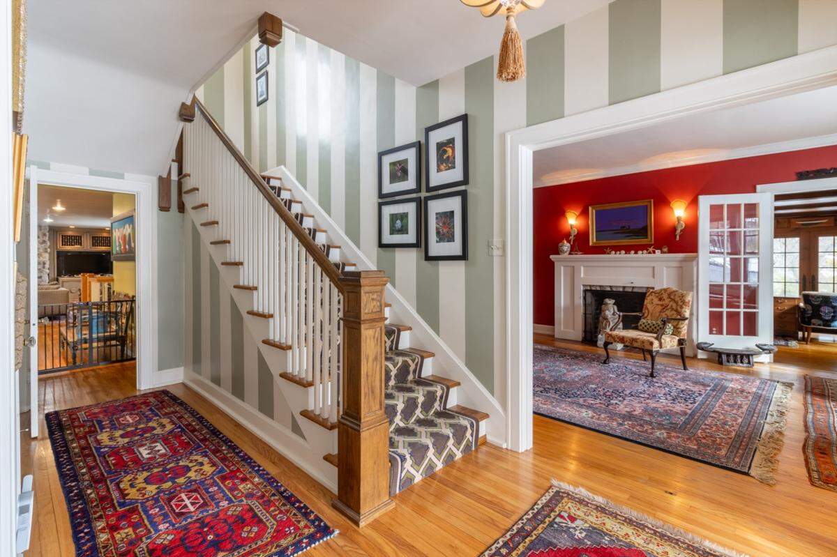 At the top of the stairs of this property for sale across from Penn State is a leaded glass window that lets light in during spring time. The property is listed for more than $1 million.