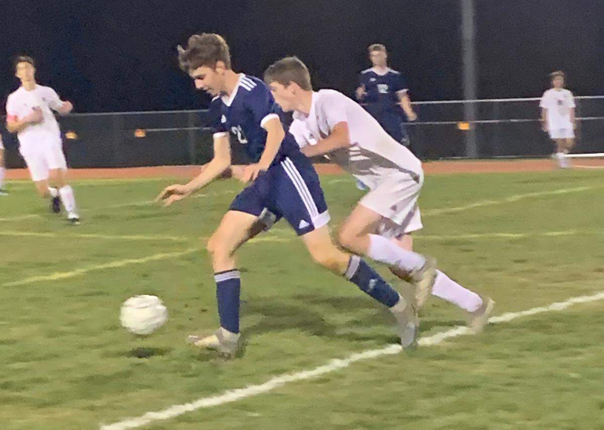 Penns Valley junior midfielder Ryan McFeely (blue jersey) collects the ball and beats a Huntingdon&nbsp;opponent in Mountain League Boys Soccer action at Penns Valley on Thursday, Oct. 15.