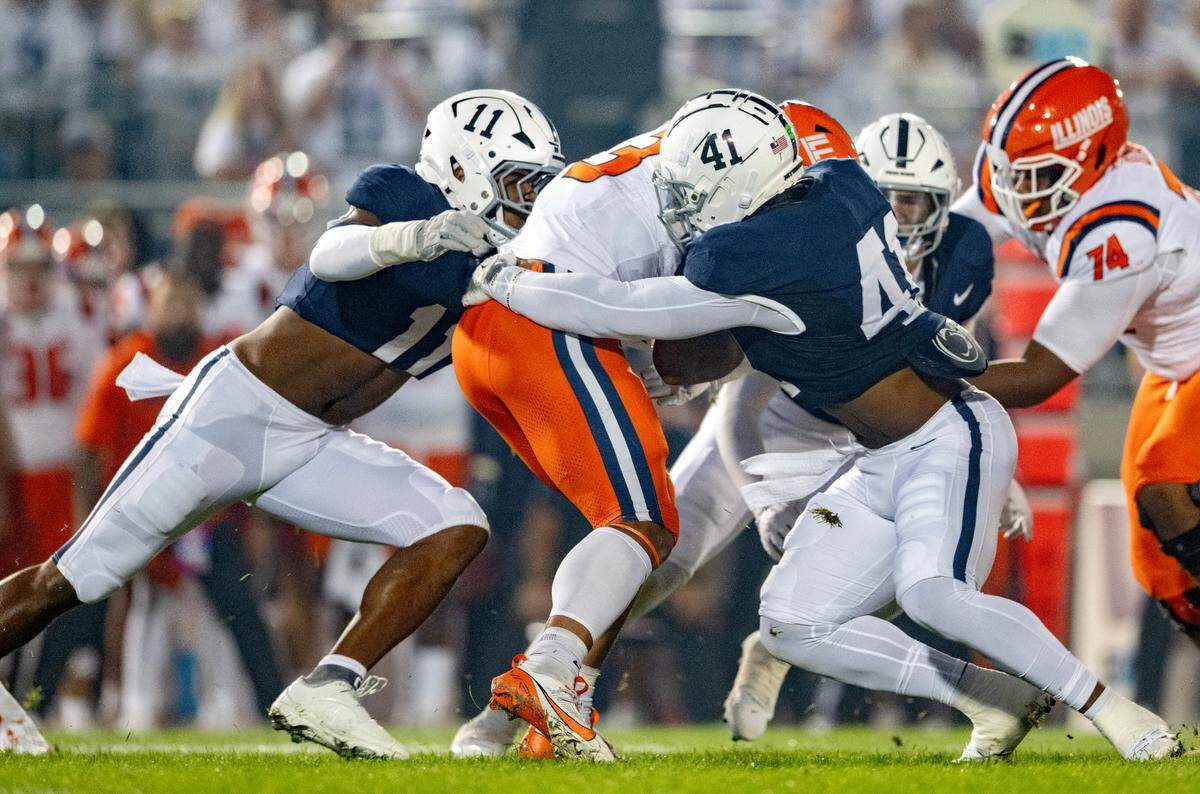 Penn State defensive end Abdul Carter and linebacker Kobe King stop Illinois running back Kaden Feagin during the game on Saturday, Sept. 28, 2024.