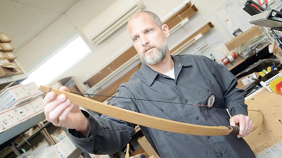 Grayvn Traditional Archers owner Ned Miller works on a hickory longbow in his Altoona workshop.