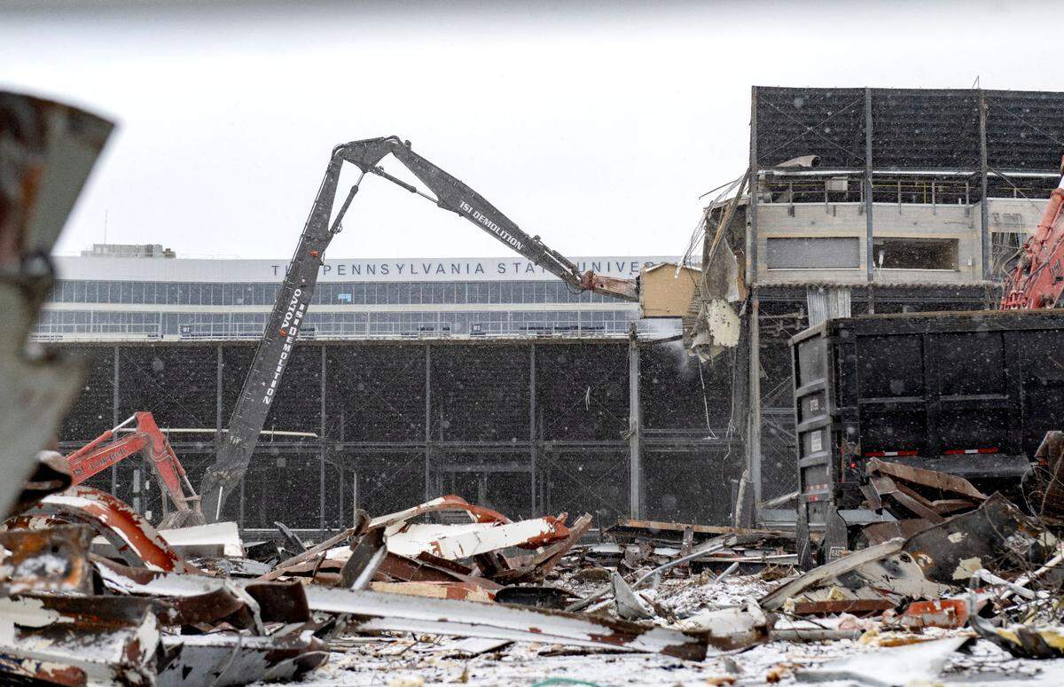 Crews work in the snow on the demolition of the west side of Beaver Stadium on Wednesday, Jan. 8, 2025.
