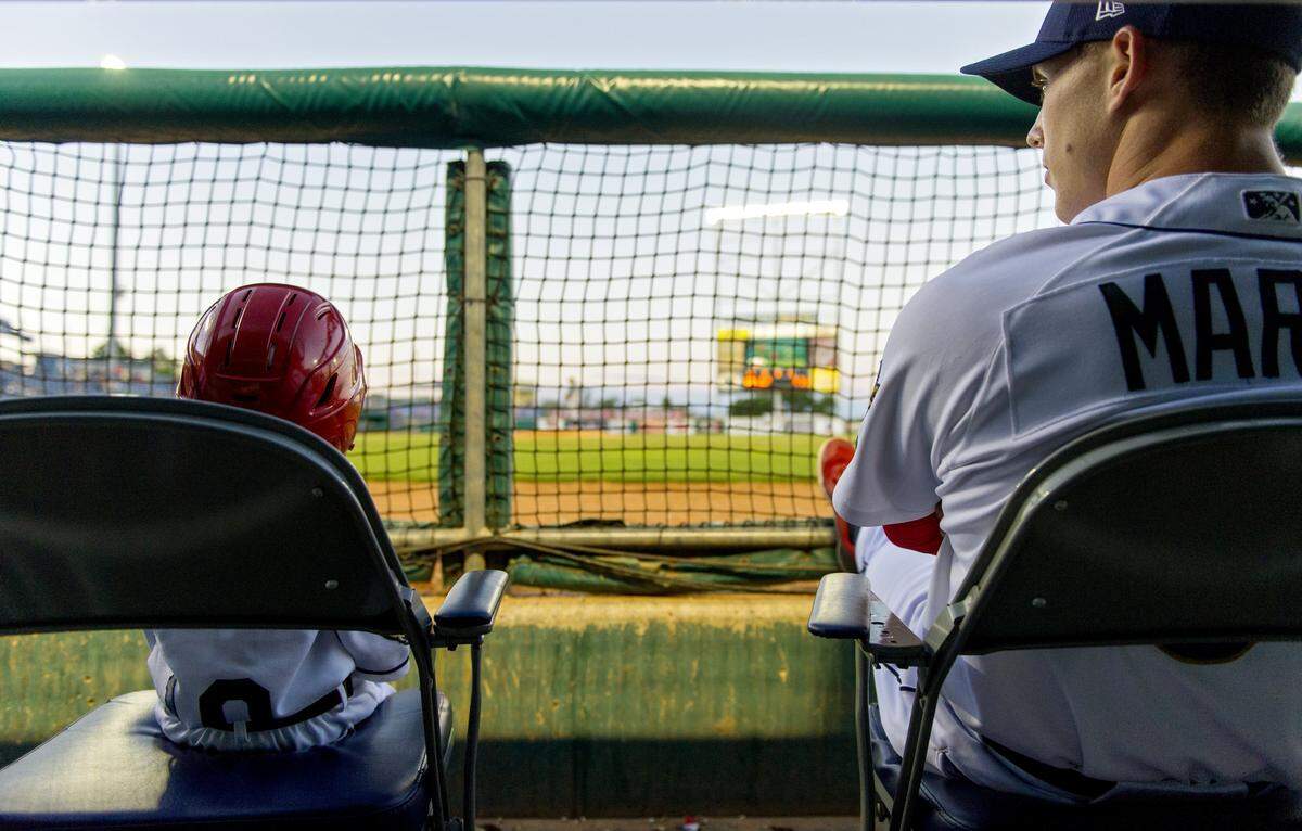 Josiah Viera sits next to Danny Martin in the dug out as they watch the June 29, 2016 Spikes game.