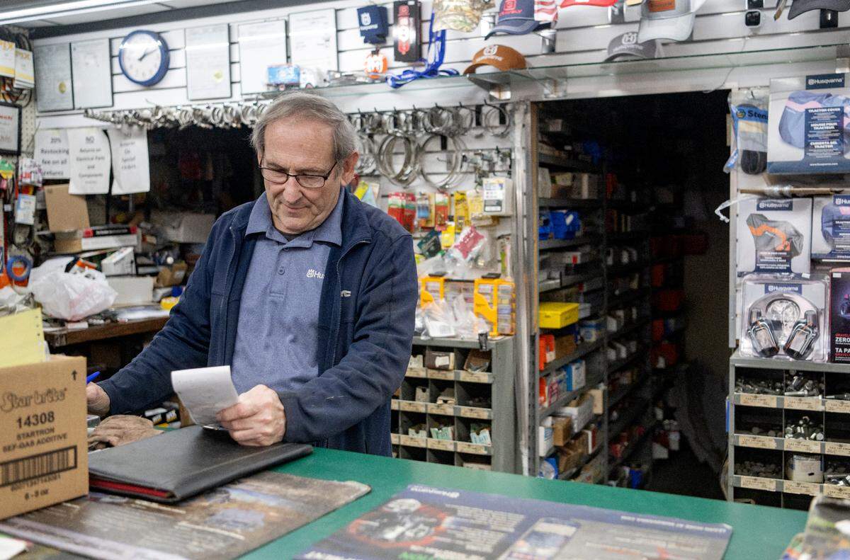 Greg Stoicheff looks at his notes to find a part for a customer at Stoicheff’s Auto Parts on North Atherton Street on Feb. 9, 2023.