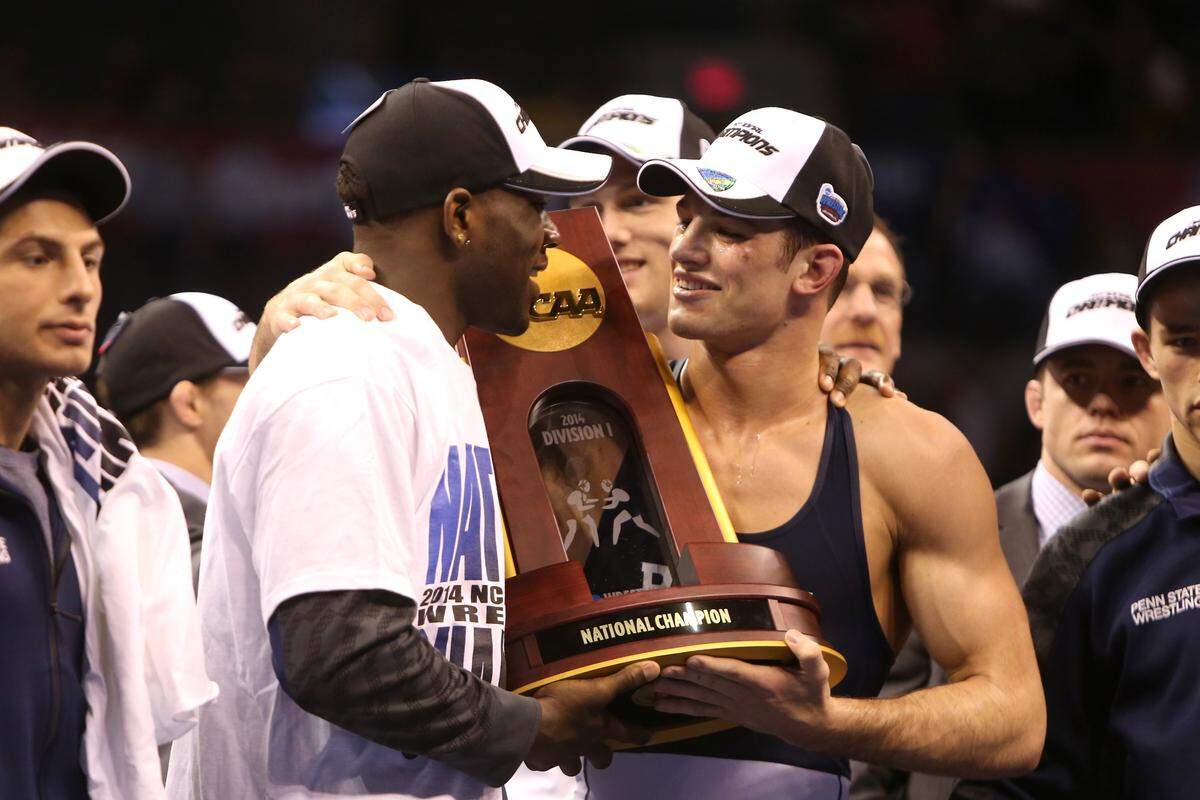 Penn State 165-pounder David Taylor and 184-pounder Ed Ruth hold the championship trophy at the NCAA 2014 Division I Wrestling Championships in the Chesapeake Energy Arena in Oklahoma City, Okla. on March 22, 2014.