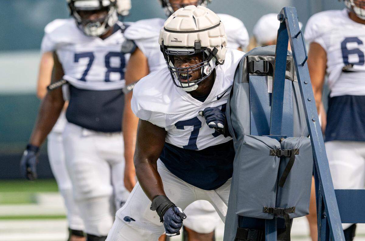 Penn State offensive lineman Olumuyiwa Fashanu runs a drill during practice on Wednesday, Aug. 10, 2022.