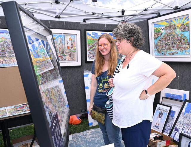 Lyndsay Temchack, left, of York, Pa., and her mother Tammy Temchack from Ginter, Pa., enjoy the artwork oft Stephen Szynal of Steve Szynal Design at the 57th Central Pennsylvania Festival of the Arts in State College Thursday, July 13, 2023.