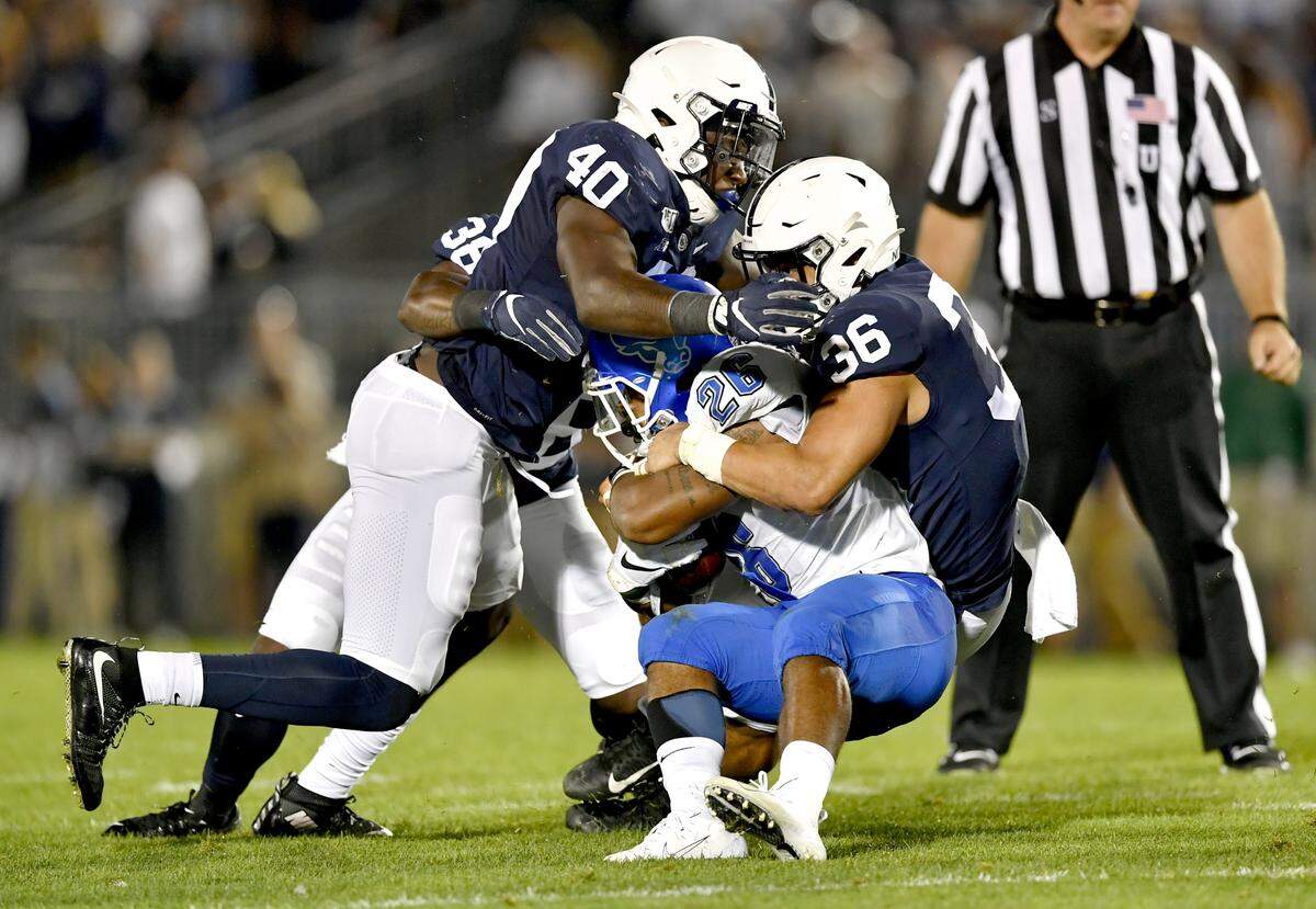 Penn State linebackers Jesse Luketa and Jan Johnson pull down Buffalo’s Jaret Patterson during the game on Saturday Sept. 7, 2019.