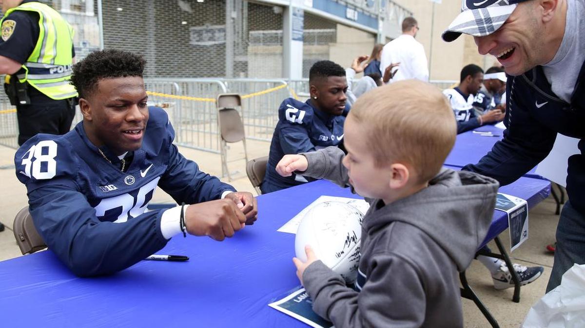Penn State cornerback Lamont Wade fist bumps Kamren Kohut, 5, during the autograph session before last season’s Blue-White Game. This year’s session will take place from 12:15 p.m. to 1:05 p.m. Saturday. Wade will be at Gate E.