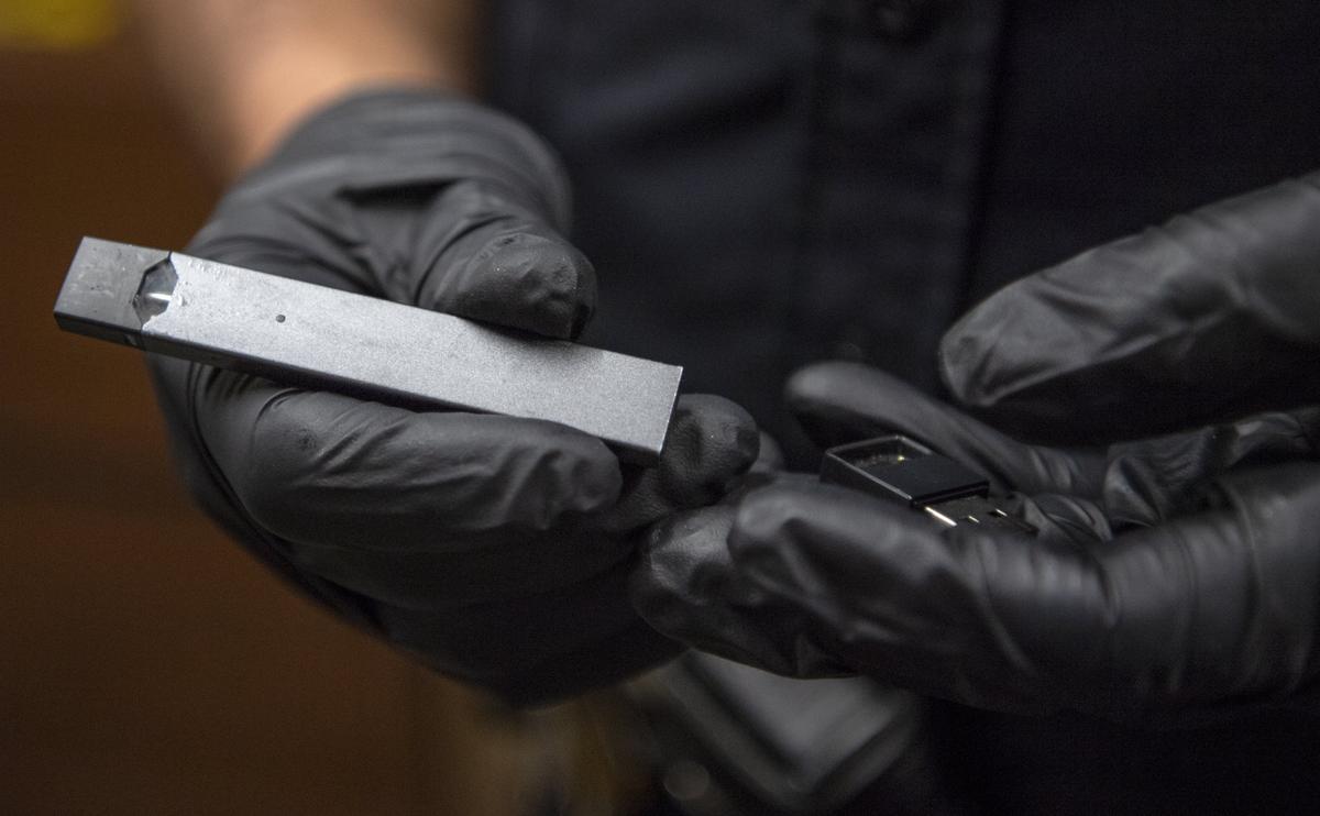 State College Area School Resource Officer John Aston shows how a confiscated vape device plugs into a USB charger.