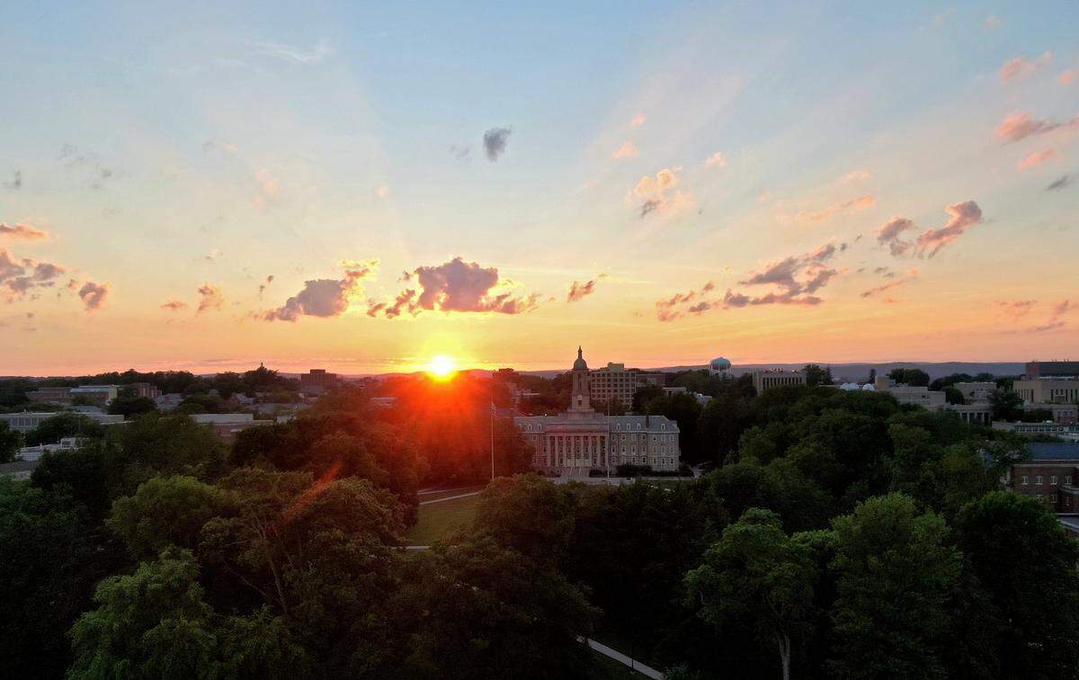 The sun sets over Old Main and the Penn State University Park campus on Sunday, June 27, 2021.