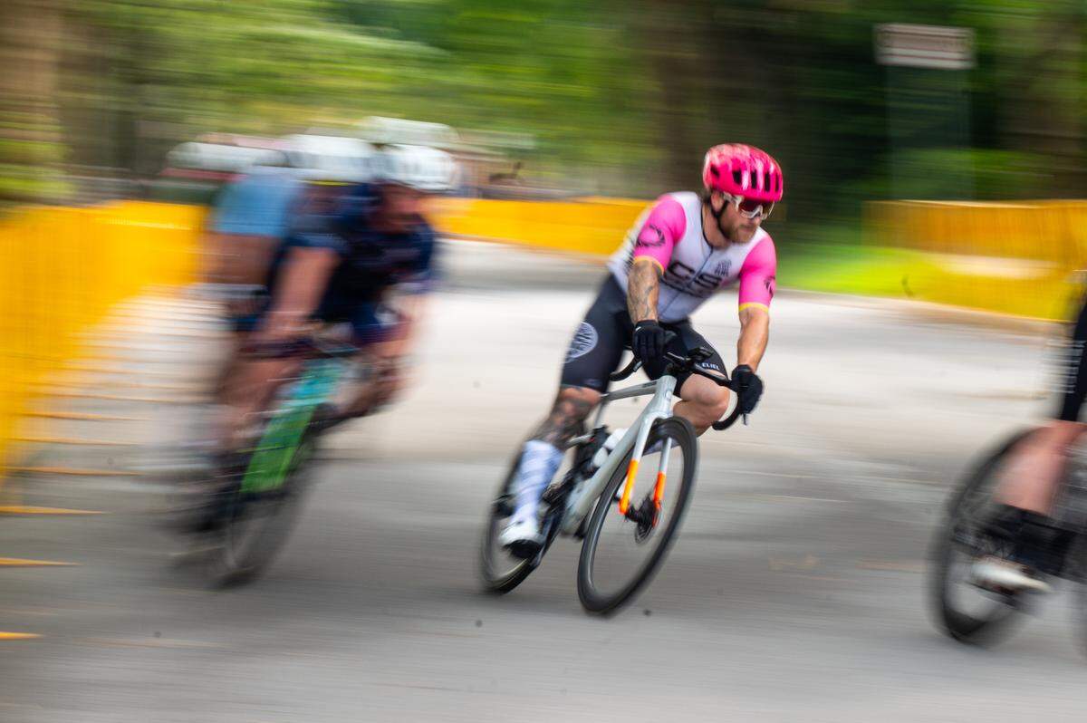 A cyclist in the Men’s Cat 1 and Cat 2 race goes around a corner during the State College Criterium on Saturday, July 26, 2025 in State College, Pa.
