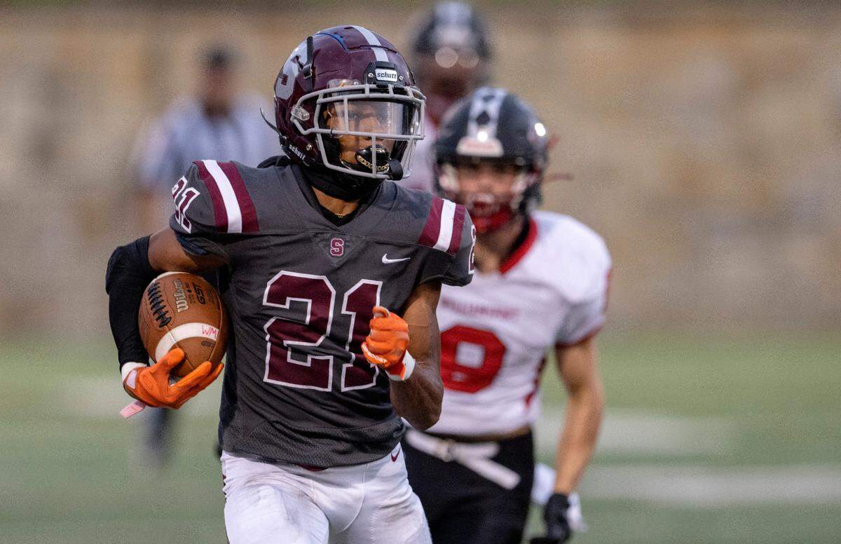 State College’s Donte Nastasi runs with the ball from Williamsport defenders during the game on Friday, Aug. 26, 2022 at Memorial Field.