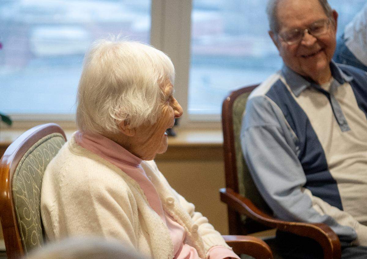 Helen Roback, 101, laughs as she talks with fellow over residents over 100 years old at Foxdale Village on Wednesday.