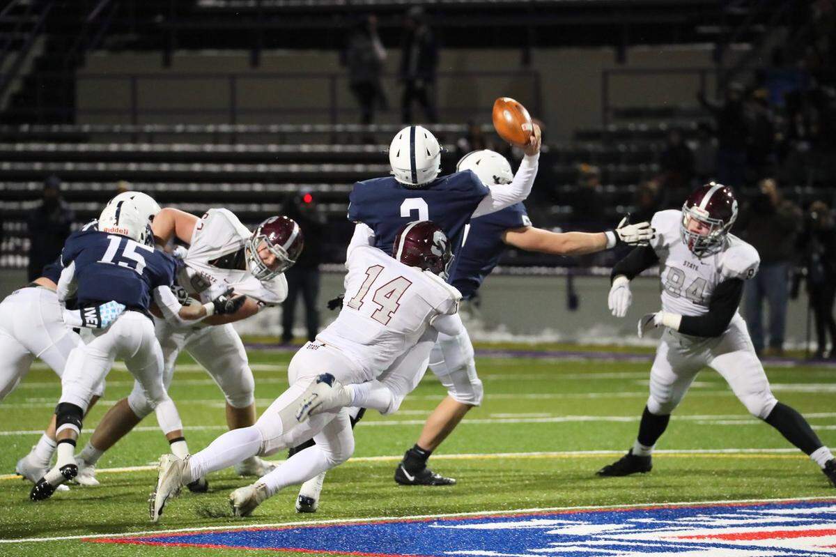 State College’s Kevin Kurzinger pulls down McDowell QB Chris Juchno on Friday in the PIAA Class 6A subregional football game at Erie Veterans Memorial Stadium in Erie. State College won 42-21.