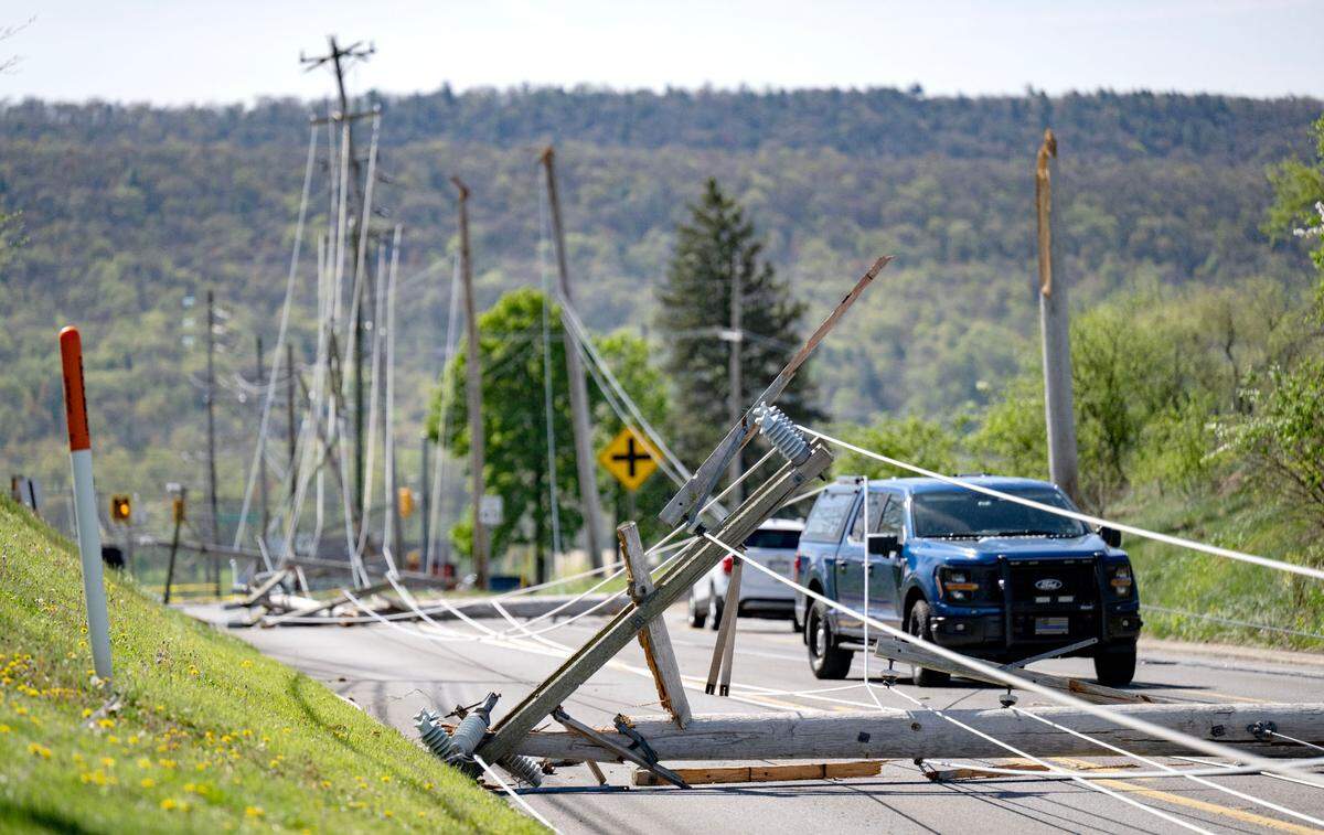 Multiple poles and wires are down across cars on West College Avenue between Whitehall Road and Bristol Avenue on Wednesday. A portion of the roadway is expected to be closed for an extended period.