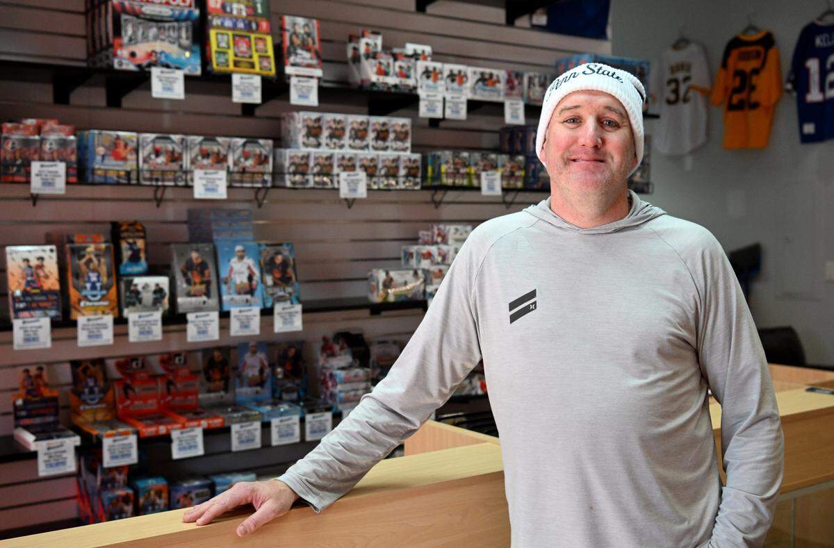Jason Dambach poses in his new shop, Nittany Cards Plus, on Wednesday, Jan. 17, 2024. The sports card store is opening soon at 1631 S. Atherton St.