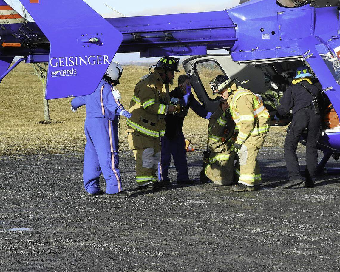 Penns Valley EMS and Boalsburg Fire company assist Life Flight with loading a patient after an accident on Route 322 on Thursday, March 3, 2022.