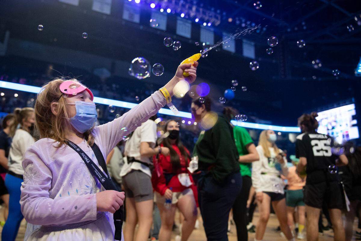 Kennedy Wilson, a Four Diamonds child, squirts a water gun during the Penn State IFC/Panhellenic Dance Marathon on Saturday.