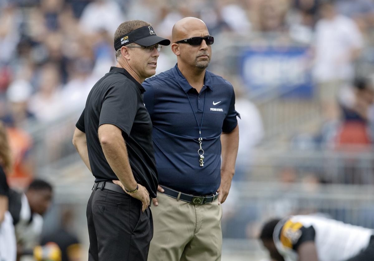 Appalachian State coach Scott Satterfield and Penn State coach James Franklin talk as they watch their players warm up before the game at Beaver Stadium on Saturday, Sept. 1, 2018.