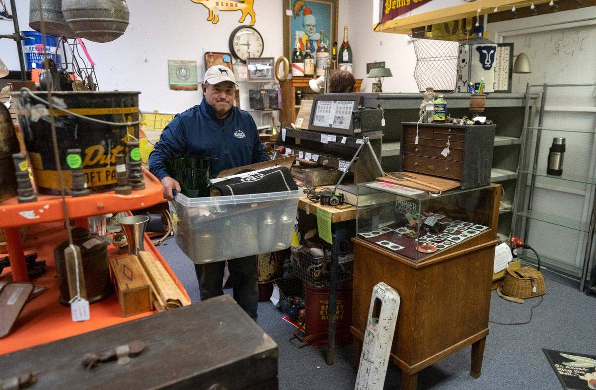 Chris Snyder packs up antiques in his space at Apple Hill Antiques on Wednesday, April 19, 2023. The antique store, which is a collection of dealers, is moving from 169 Gerald St. to 2221 E. College Ave.