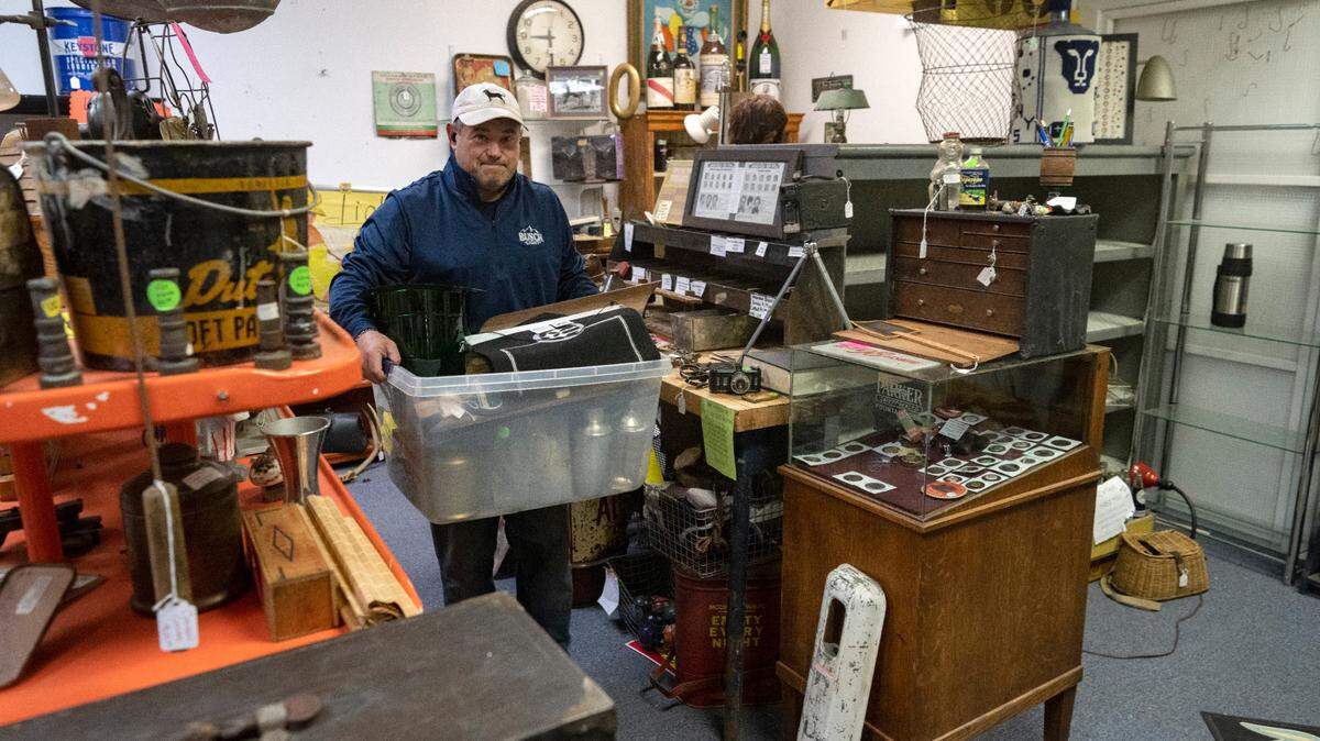 Chris Snyder packs up antiques in his space at Apple Hill Antiques on Wednesday, April 19, 2023. The antique store, which is a collection of dealers, is moving from 169 Gerald St. to 2221 E. College Ave.