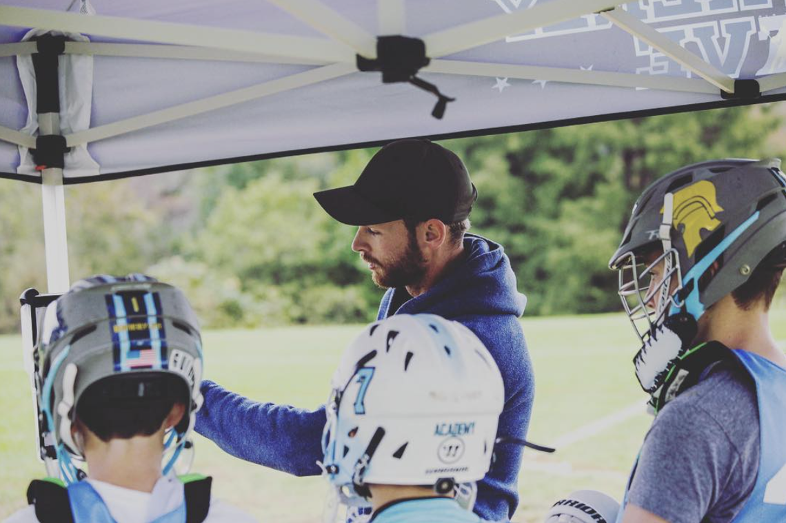 Drew Adams coaches young lacrosse players in 2018.