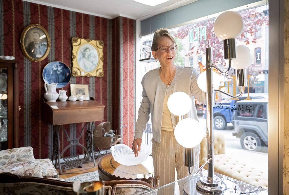 Mary Pritchard turns on a vintage lamp at The Great Mish Mosh in Bellefonte. 