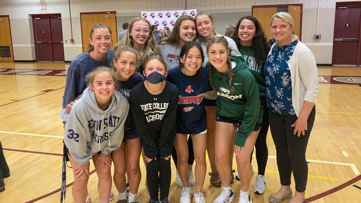 State College girls’ lacrosse players pose for a photo with coach Tara Hohenshelt on Wednesday, June 2, 2021, at the high school’s signing day event in the North Gym.