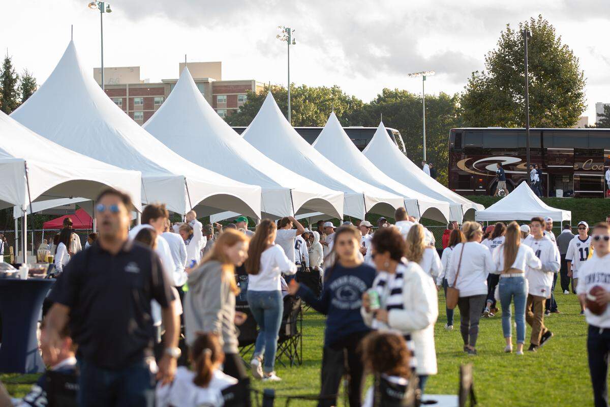 Fans walk among the tents in the Tailgate Guys area before a Penn State game. Courtesy of Tailgate Guys.
