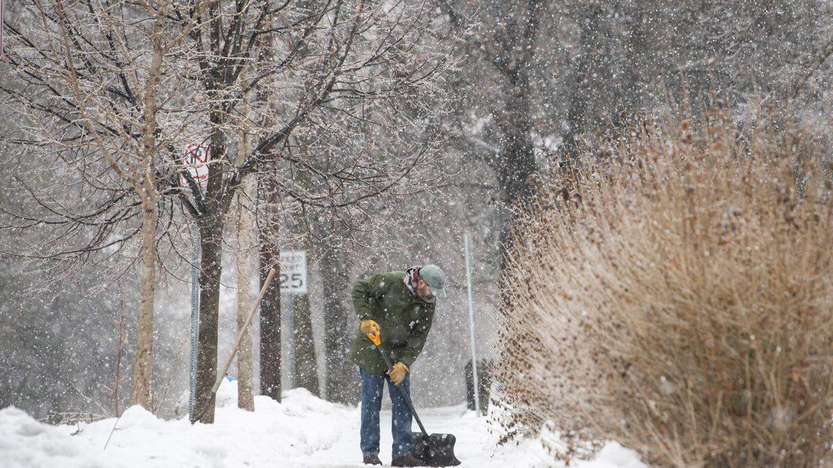 Jonathan Ziegler shovels snow Friday following a storm that brought snow and ice to State College.