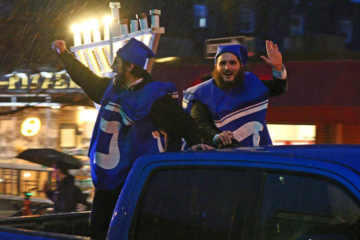 Twenty-five cars took part in the Menorah Car Parade Sunday in downtown State College before the lighting of a 6 foot tall public Jewish Hanukkah menorah at Old Main.