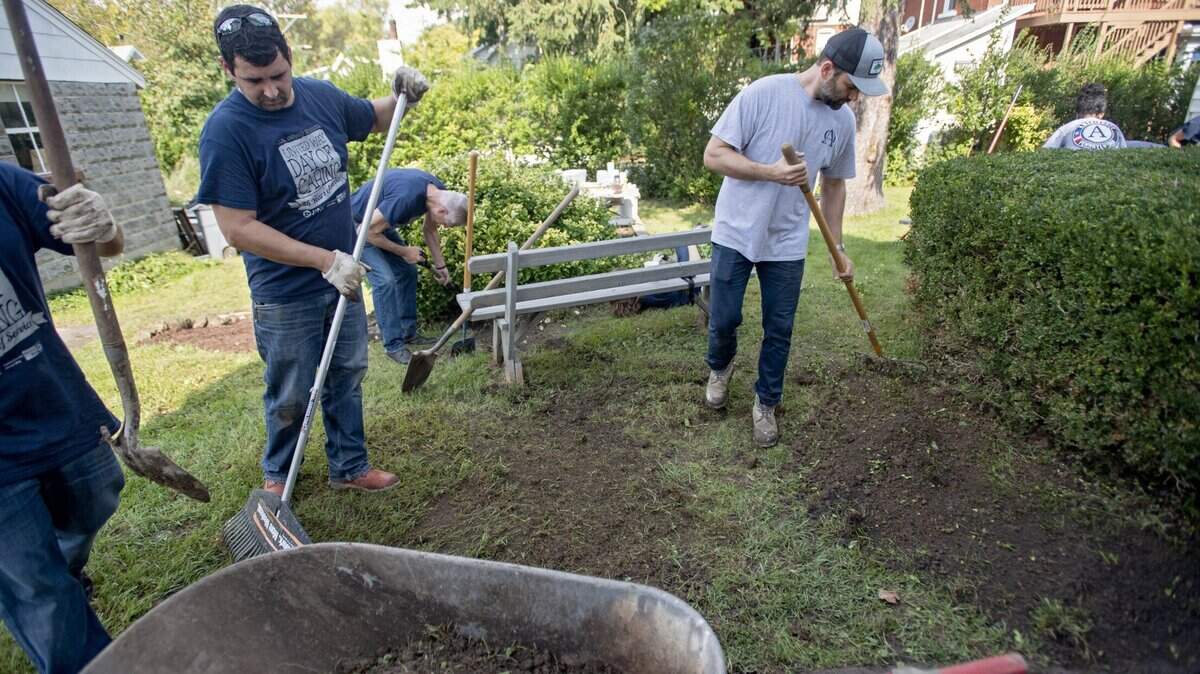 State College borough workers help Jamison Malcolm as they create a new waterway behind the Meeting House on Atherton Street during the United Way 25th Annual Day of Caring on Thursday, Oct. 4, 2018.