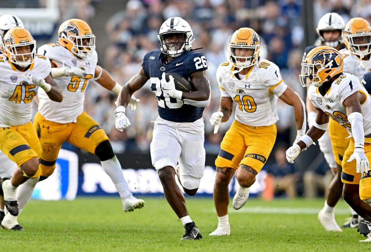 Penn State running back Cam Wallace cuts down the field with the ball from Kent State defenders during the game on Saturday, Sept. 21, 2024 at Beaver Stadium.  