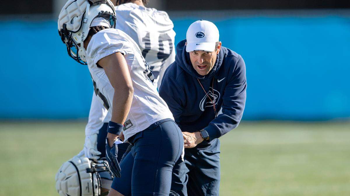 Penn State defensive coordinator Manny Diaz goes over a technique with a player during the first day of spring practice on March 21.