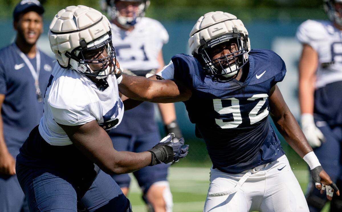 Penn State offensive lineman Olumuyiwa Fashanu and defensive end Smith Vilbert run a drill during practice on Saturday, Aug. 20, 2022.